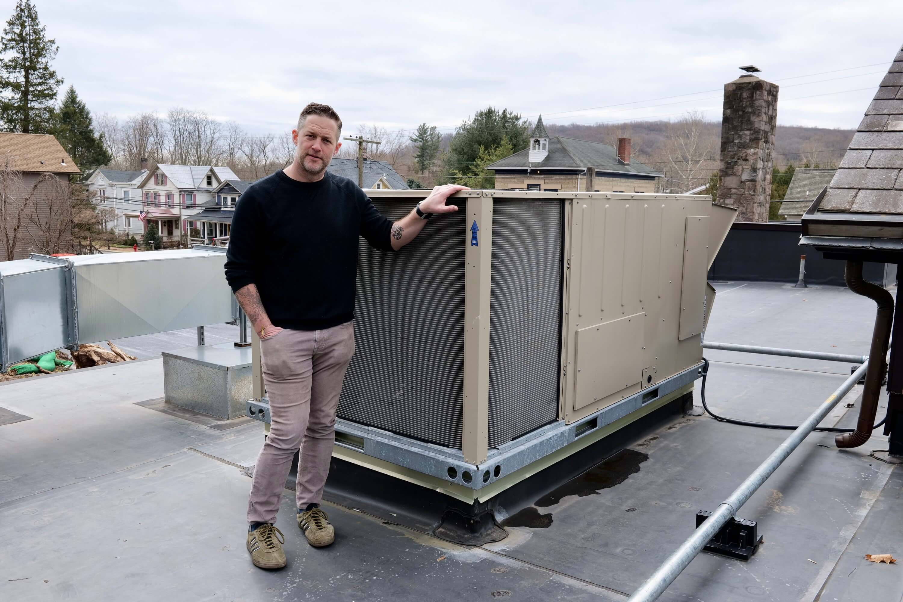 Anthony Rudolf, Managing Partner of the Stockton Inn, showing one of three rooftop economizers at the Stockton Inn